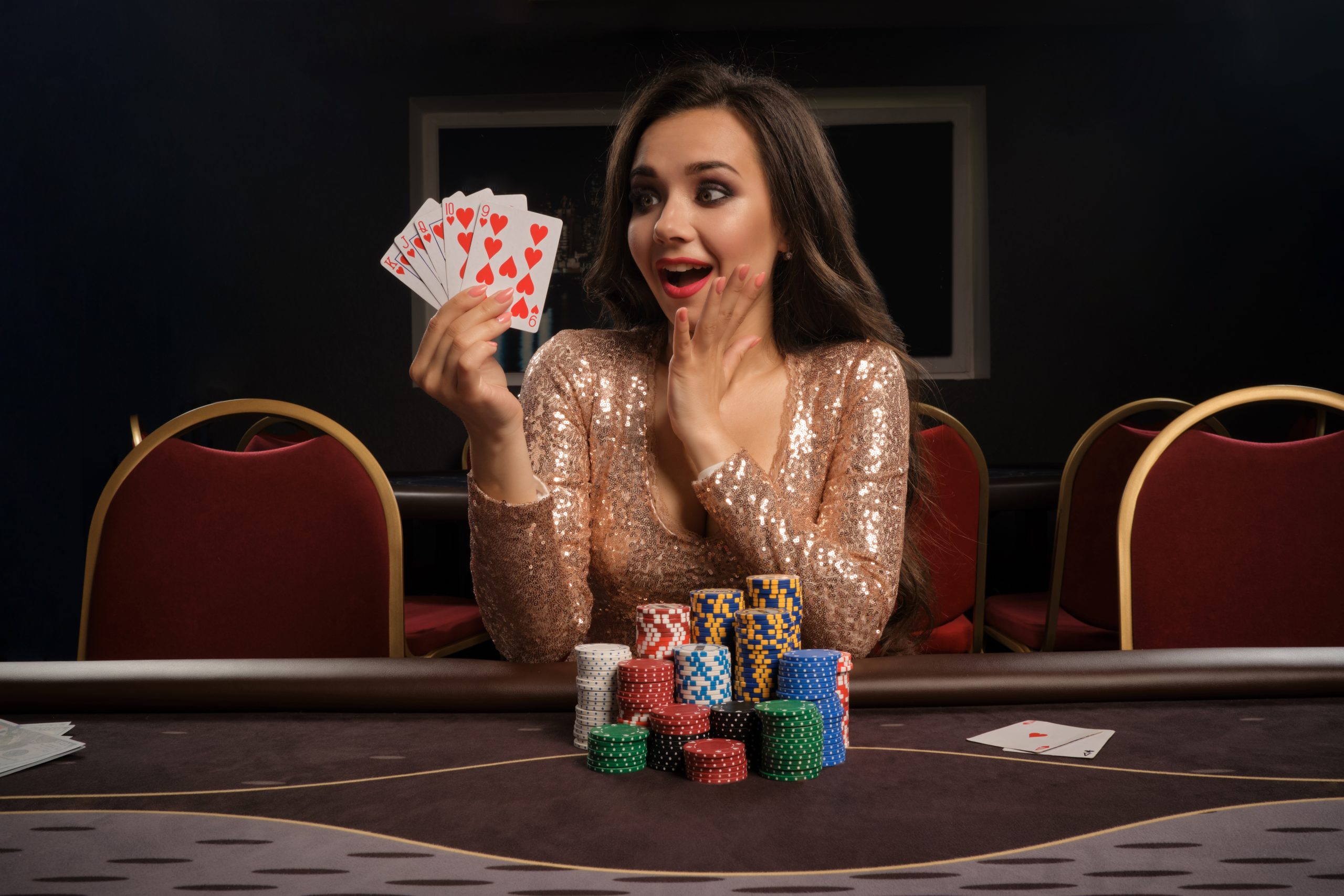 happy-brunette-girl-brilliant-gold-dress-is-playing-poker-sitting-table-casino-she-is-making-bets-waiting-big-win-showing-her-cards-gambling-money-games-fortune-scaled